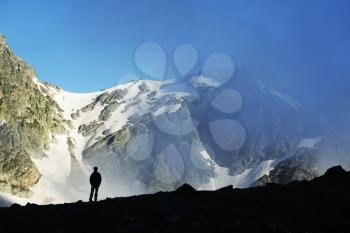 Royalty Free Photo of a Silhouette of a Boy in the Mountains
