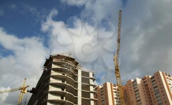 Royalty Free Photo of a Crane Over a New Building