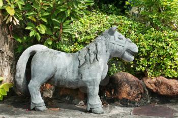 Royalty Free Photo of a Stone Horse Sculpture in a Garden