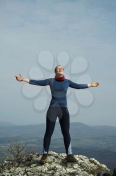 Royalty Free Photo of a Woman with Arms Open on a Mountaintop
