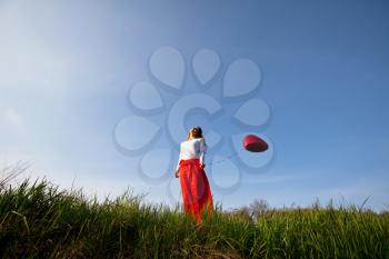Royalty Free Photo of a Woman in a Field Holding a Balloon