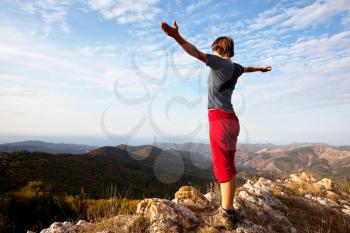 Royalty Free Photo of a Girl on Top of a Mountain