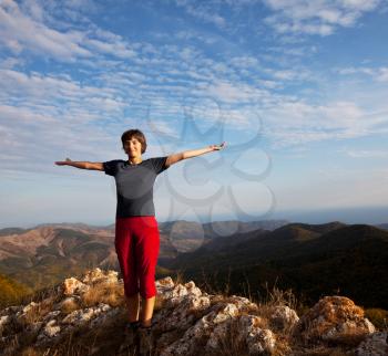 Royalty Free Photo of a Woman Standing on a Mountain