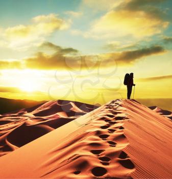 Royalty Free Photo of a Silhouette of a Backpacker in the Desert