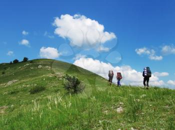Royalty Free Photo of Three Hikers on a Hill