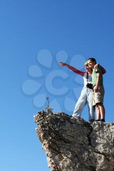 Royalty Free Photo of a Man and Woman Standing on a Cliff