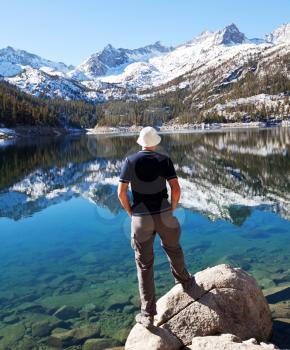 Royalty Free Photo of a Man Looking at a Mountain Lake