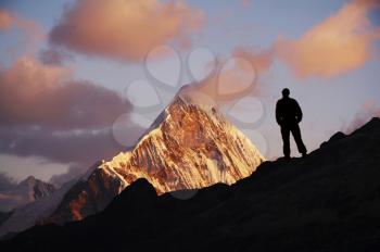 Royalty Free Photo of a Silhouette of a Man on a Mountain