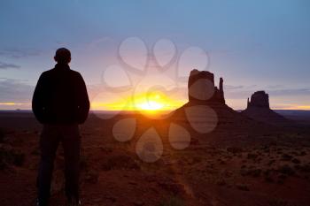 Royalty Free Photo of a Man Standing in Monument Valley in Utah, USA