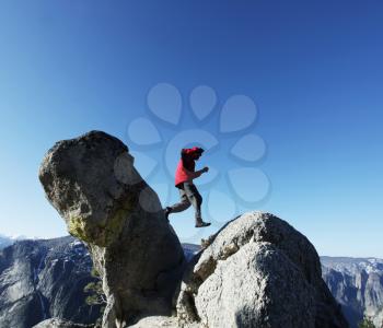 Royalty Free Photo of a Man Jumping from Rock to Rock in Yosemite National Park