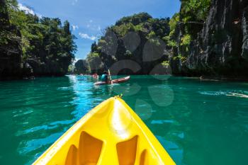 Kayak in the island lagoon between mountains. Kayaking journey in El Nido, Palawan, Philippines.