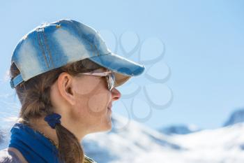 Hiking young woman with winter mountains 