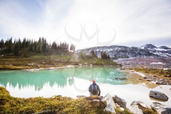 Hiker relaxing at serene mountain lake