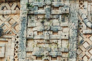 Ancient wall with carved Mayan  ornament , Uxmal, Yucatan, Mexico. UNESCO world heritage site