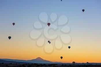 Colorful hot air balloons  in Goreme national park, Cappadocia, Turkey. Famous touristic attraction.