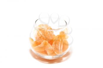 Tangerine segments in a glass bowl on a white background