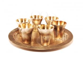 The gilt wine-glasses and tray on a white background