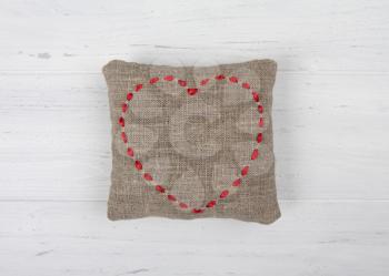 Pillow heart on white wooden background