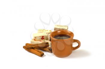 Coffee, sweets and cinnamon isolated on a white background