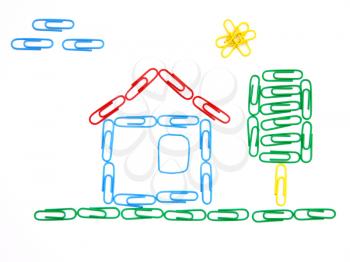 The house and tree from color paper clips on a white background with clouds and the sun