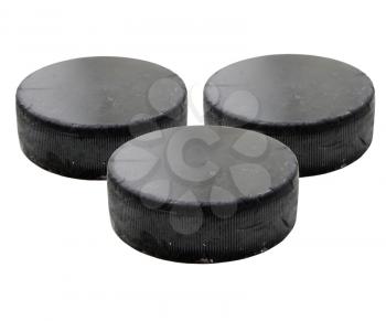 Three old black hockey puck isolated on white background.