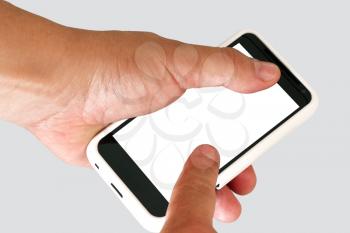 Mobile phone  in a man's hand. Isolated on a grey background.