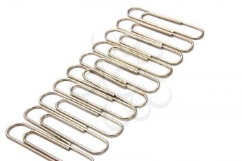 The metal paper clip lies on a white background