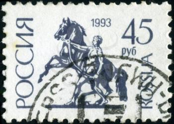 RUSSIA - CIRCA 1992: A stamp printed in Russia shows Sculpture rider leading the horse by the bridle on Anichkov Bridge in St Petersburg, circa 1992