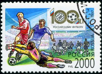 RUSSIA - CIRCA 1997: A post stamp printed Russia , shows 100th anniversary of the 1997 domestic football, soccer ball, behind the Russian Football Cup, circa 1997
