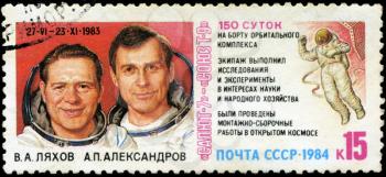 USSR - CIRCA 1984: stamp printed in USSR, shows Spacecraft complex Salyut-7 and Soyuz T-9, portraits of cosmonauts V.A Lyahov and A.P.Aleksandrov 150-day flight of Cosmos, circa 1984