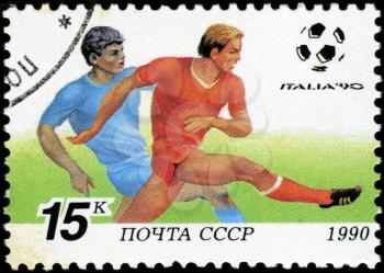 USSR - CIRCA 1990: a stamp printed by USSR shows football players. World football cup in Italy, series, circa 1990
