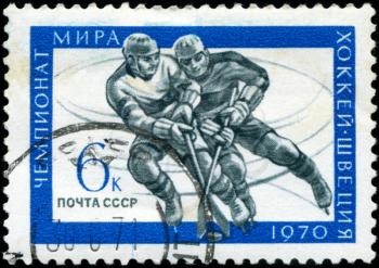 USSR - CIRCA 1970: A stamp printed in USSR, hockey, two athletes play hockey, circa 1970