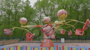 MOSCOW, RUSSIA, May 21, 2017: Children go in carousel and having fun on a cloudy day, Moscow