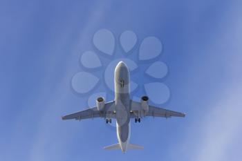 Airplane flies against a background of white clouds