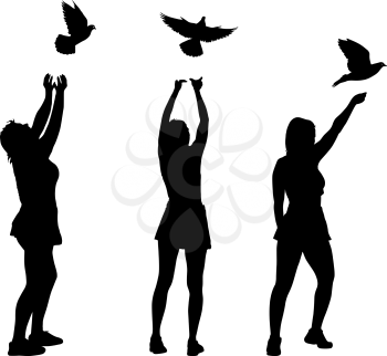 Silhouette of three girls let a dove in the sky.
