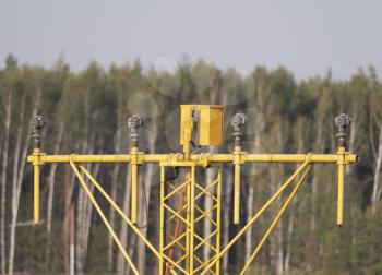 Yellow metal support systems of care during takeoff and landing direction light near runway.