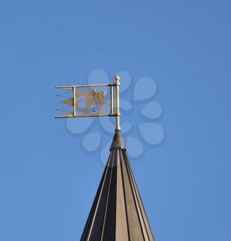 Golden dome with orthodox cross close-up on a blue sky background.