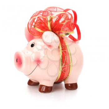 Christmas deposit concept. Piggy bank with festive bow isolated on white.