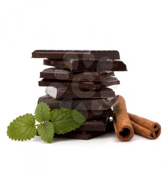 Chocolate bars stack and cinnamon sticks isolated on white background