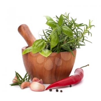 fresh flavoring herbs and spices in wooden mortar isolated on white background