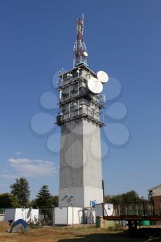 Royalty Free Photo of a Large Telecommunications Tower with Supporting Infrastructure
