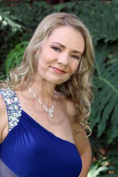 Portrait of Lovely blond lady outdoors in evening gown