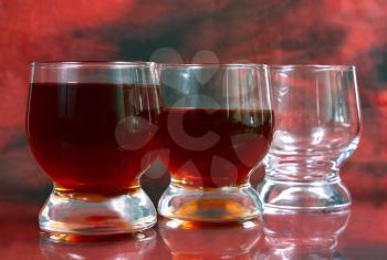 alcohol drink is in a glass on red background