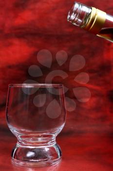 glass for a alcohol drink on red background
