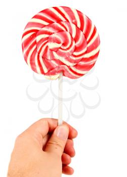 candy pink spiral lollipop in hand isolated on white background