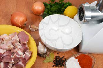 raw meat with spices and meat grinder for preparation of stuffing