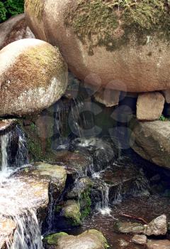 waterfall with water which flows between stones