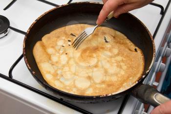 Frying a pancake cooking in a pan 