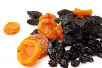 dried apricots, prunes and raisins on a white background
