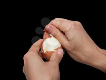 cleaning hands a boiled egg on a black background